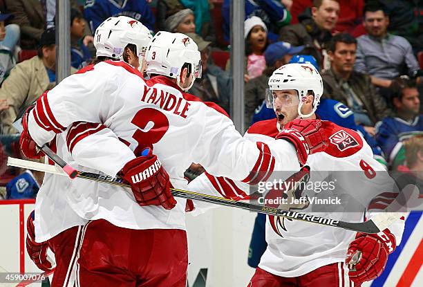 Keith Yandle and Tobias Rieder congratulate Martin Hanzal of the Arizona Coyotes who scored against the Vancouver Canucks during their NHL game at...