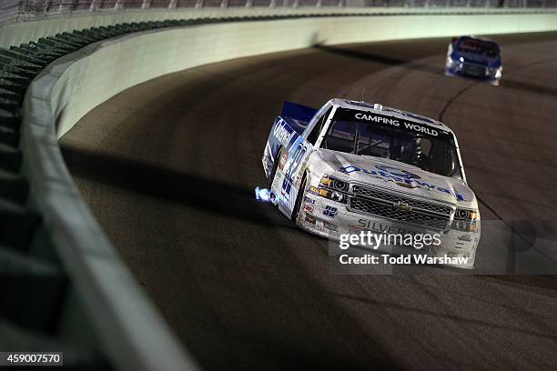 Tayler Malsam, driver of the Outerwall Chevrolet, leads a pack of trucks during the NASCAR Camping World Truck Series Ford EcoBoost 200 at...