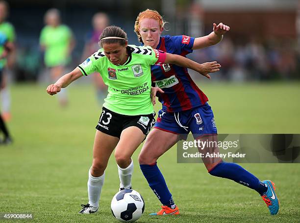 Victoria Huster of the Jets and Nicole Begg of Canberra contest the ball during the round 10 W-League match between Newcastle and Canberra at Jack...