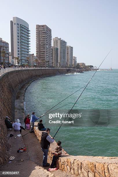 fishing people in the corniche of beirut, lebanon - beiroet beach stockfoto's en -beelden