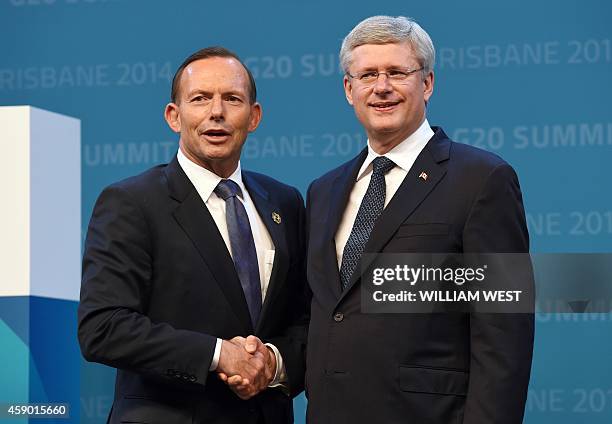 Australia's Prime Minister Tony Abbott officially welcomes Canada's Prime Minister Stephen Harper to the G20 Leaders' Summit in Brisbane on November...