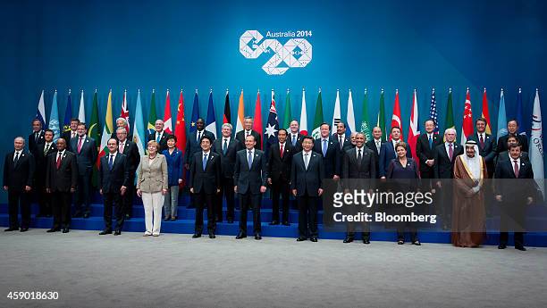 World leaders and delegates pose for a family photograph at the Group of 20 summit in Brisbane, Australia, on Saturday, Nov. 15, 2014. Front row,...