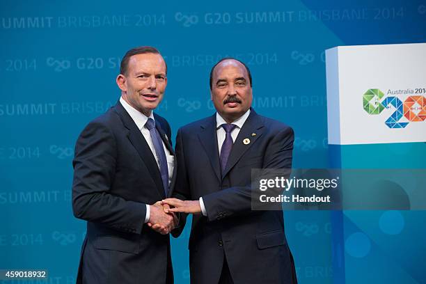 In this handout photo provided by the G20 Australia, Australian Prime Minister Tony Abbott greets Mauritania's President Mohamed Ould Abdel Aziz...