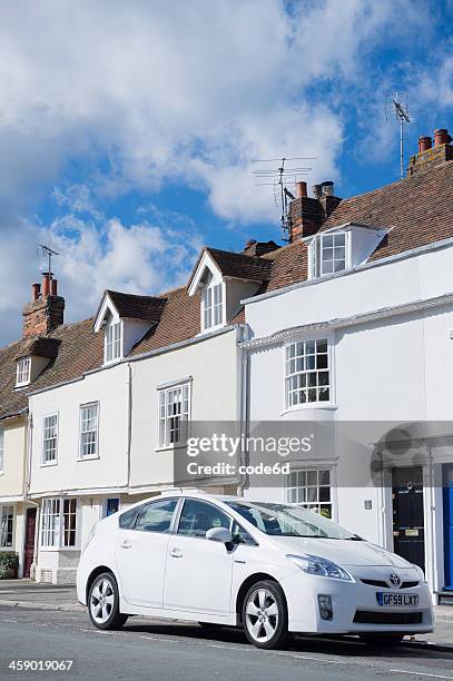 toyota prius parked in front of residence - white prius stock pictures, royalty-free photos & images