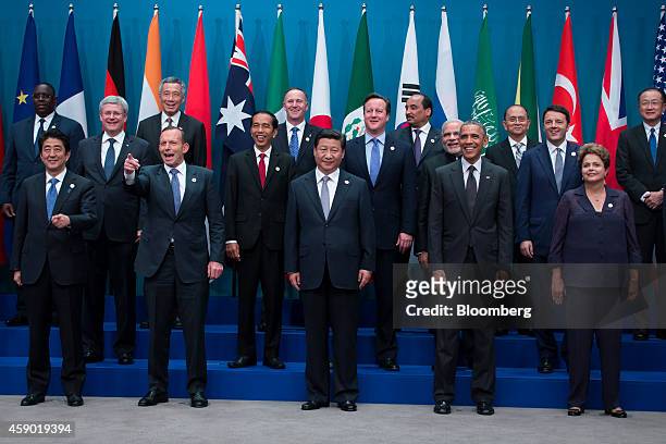 World leaders and delegates pose for a family photograph at the Group of 20 summit in Brisbane, Australia, on Saturday, Nov. 15, 2014. Front row,...