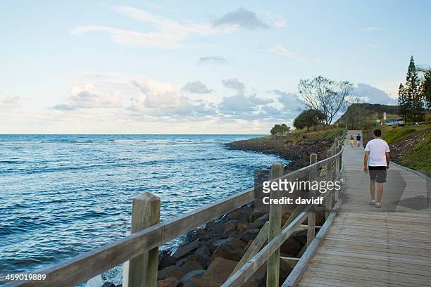 sunset beachside exercise - boardwalk australia stock pictures, royalty-free photos & images