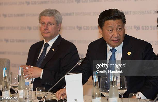 In this handout photo provided by the G20 Australia, Canada's Prime Minister Stephen Harper and China's President Xi Jinping attend a dinner hosted...