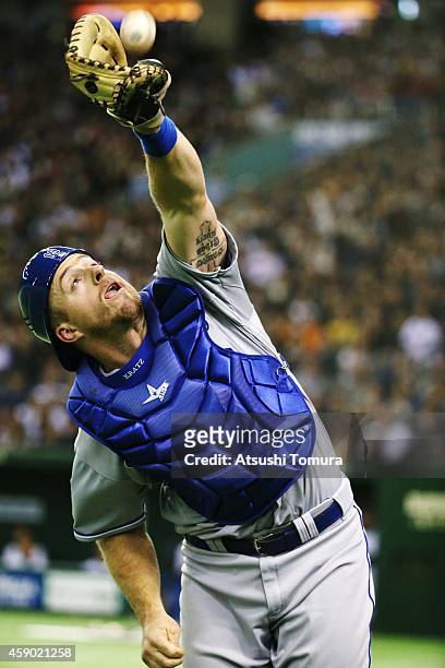 Erik Kratz of the Kansas City Royals makes a catch on in the eighth inning during the game three of Samurai Japan and MLB All Stars at Tokyo Dome on...