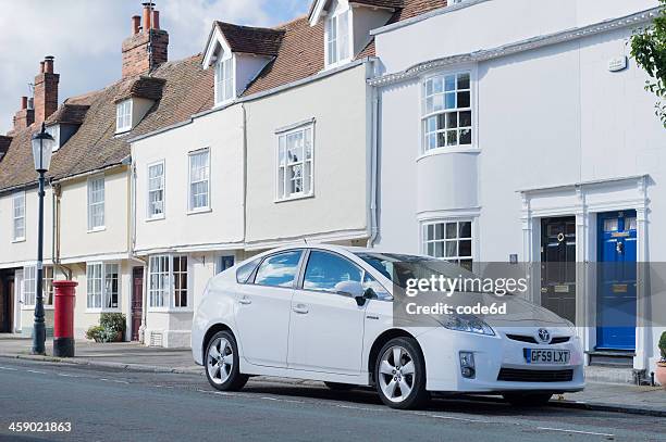 toyota prius parked in front of residence - white prius stock pictures, royalty-free photos & images