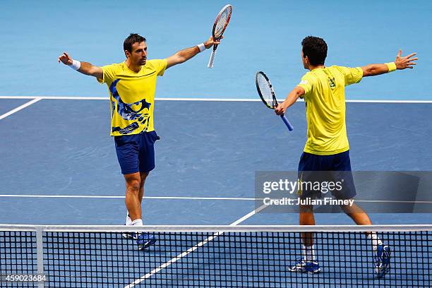 Marcelo Melo of Brazil and Ivan Dodig of Croatia celebrate match point in the doubles semi-final match against Lukasz Kubot of Poland and Robert...