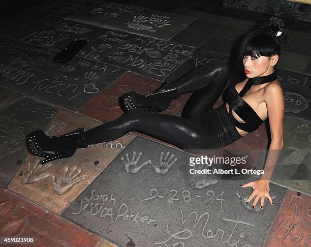 Actress Bai Ling poses on Martin Landau's and sarah Jessica Parker's foot & Handprints from "Ed Wood" at the Nerds Like Us Presentation of "The Crow"...