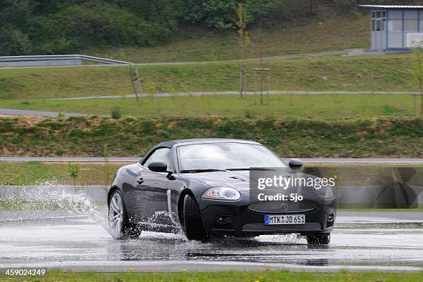 jaguar xkr skidding - sked stock pictures, royalty-free photos & images