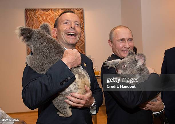In this handout photo provided by the G20 Australia, Australia's Prime Minister Tony Abbott and Russia's President Vladimir Putin meet Jimbelung the...