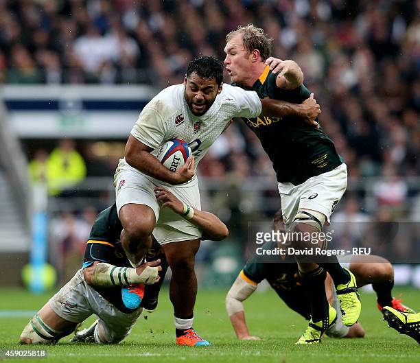 Billy Vunipola of England is tackled by Schalk Burger of South Africa during the QBE Intenational match between England and South Africa at...
