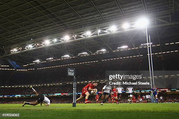 Alex Cuthbert of beats Asaeli Tikoirotuma and Vereniki Goneva of Fiji to score his sides second try during the International match between Wales and...