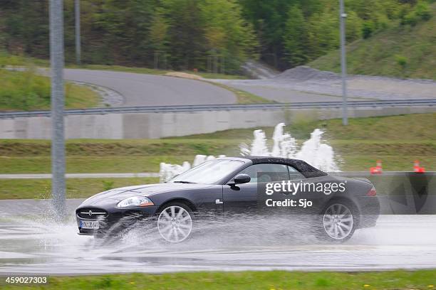 jaguar xkr skidding - sked stock pictures, royalty-free photos & images