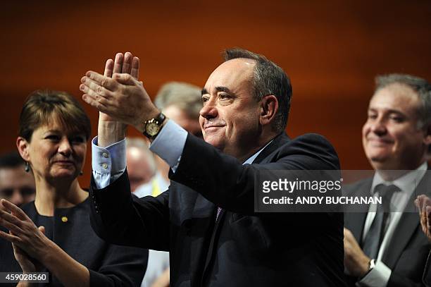 Scotland's First Minister Alex Salmond applauds New leader of the Scottish National Party Nicola Sturgeon after she delivers her first keynote speech...