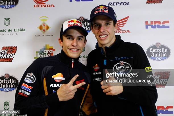 Moto GP world champion Repsol Honda Team's Spanish rider Marc Marquez and his young brother Moto 3 world champion Estrella Galicia 0,0's Spanish...