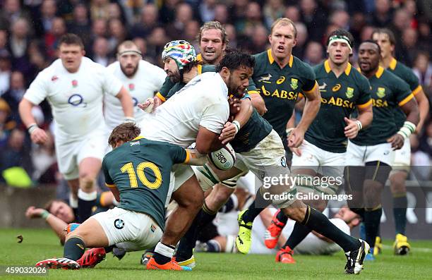 Victor Matfield and Pat Lambie of South Africa tackling Billy Vunipola of England during the QBE International match between England and South Africa...