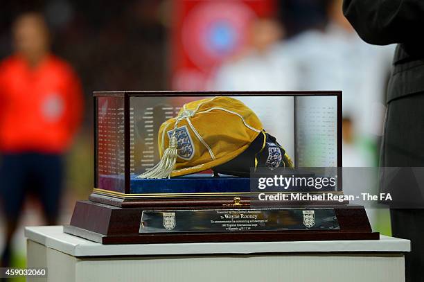 Wayne Rooney of England's 100th cap rests on a plinth before being awarde by Sir Bobby Charlton prior to the EURO 2016 Group E Qualifier match...