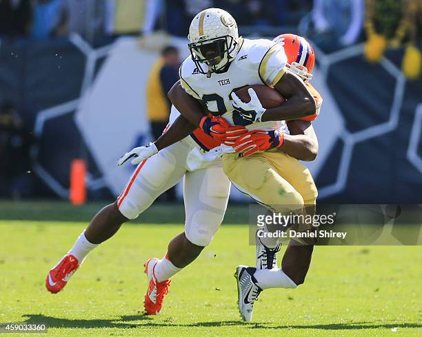Broderick Snoddy of the Georgia Tech Yellow Jackets suffers an injury as he is tackled by Stephone Anthony of the Clemson Tigers on a run play during...