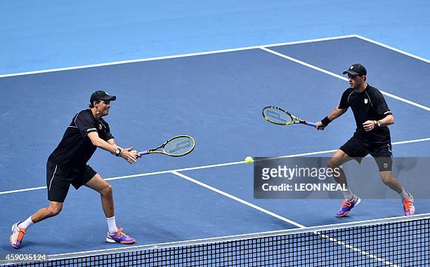 Mike Bryan and Bob Bryan of the US return to France's Julien Benneteau and France's Edouard Roger-Vasselin during their semi-final doubles match on...