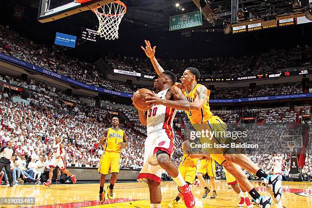 Norris Cole of the Miami Heat drives to the basket against Dominic McGuire of the Indiana Pacers in Game Seven of the Eastern Conference Finals...