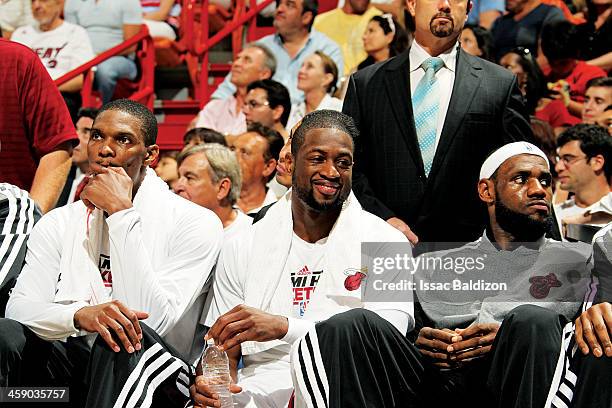 Chris Bosh, Dwyane Wade and LeBron James of the Miami Heat look on from the bench during a game between the Chicago Bulls and the Miami Heat on April...