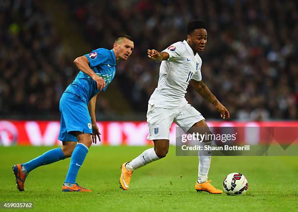 Andraz Kirm of Slovenia and Raheem Sterling of England during the EURO 2016 Qualifier Group E match between England and Slovenia at Wembley Stadium...