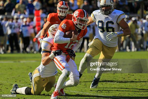 Nick Schuessler of the Clemson Tigers is sacked by Tyler Marcordes of the Georgia Tech Yellow Jackets during the second half Bobby Dodd Stadium on...