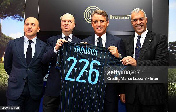 Piero Ausilio, Marco Fassone, new coach of FC Internazionale Milano Roberto Mancini and Michael Bolingbroke during a press conference at the club's...
