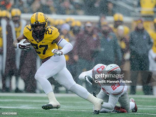 David Cobb of the Minnesota Golden Gophers avoids a tackle by Tyvis Powell of the Ohio State Buckeyes during the second quarter of the game on...