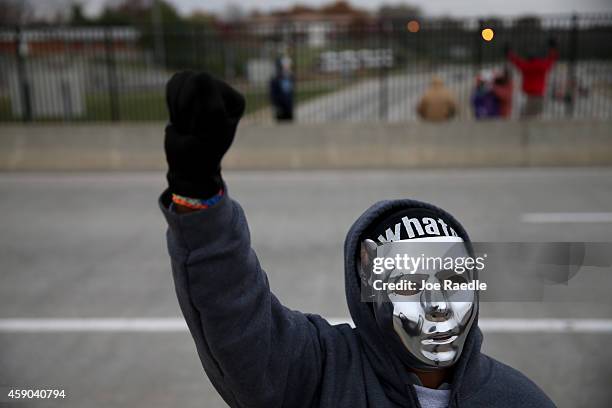 Demonstrators yell "Hands Up, Don't Shoot" alongside a highway overpass to voice their opinions as the area awaits a grand jury decision on November...