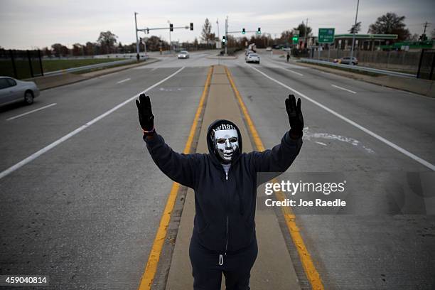 Demonstrators yell "Hands Up, Don't Shoot" alongside a highway overpass to voice their opinions as the area awaits a grand jury decision on November...