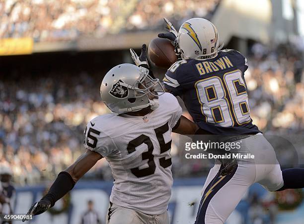 Vincent Brown of the San Diego Chargers goes up for the ball against Chimdi Chekwa of the Oakland Raiders on December 22, 2013 at Qualcomm Stadium in...