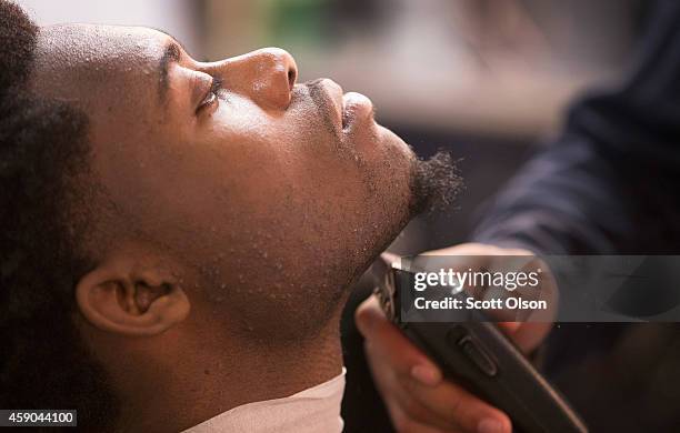 Caron Payne get his beard trimmed at the Prime Time Barber and Beauty shop on West Florissant Street November 15, 2014 in Ferguson, Missouri....