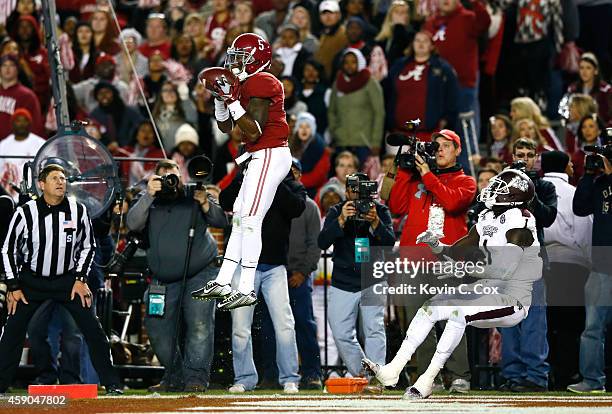 Cyrus Jones of the Alabama Crimson Tide intercepts a touchdown reception intended for De'Runnya Wilson of the Mississippi State Bulldogs at...