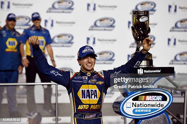 Chase Elliott, driver of the NAPA Auto Parts Chevrolet, celebrates with the trophy in Victory Lane after winning the series championship after the...