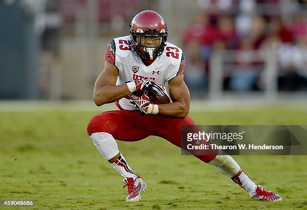 Devontae Booker of the Utah Utes carries the ball against the Stanford Cardinal in the second quarter at Stanford Stadium on November 15, 2014 in...