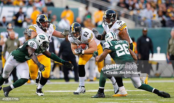 Heath Miller of the Pittsburgh Steelers in action against Dawan Landry and Demario Davis of the New York Jets on November 9, 2014 at MetLife Stadium...