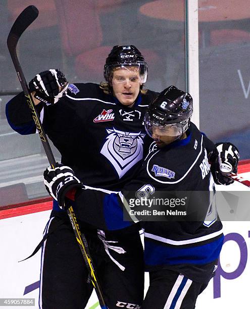 Axel Blomqvist of the Victoria Royals celebrates his goal against the Vancouver Giants with teammate Travis Brown during the first period of their...