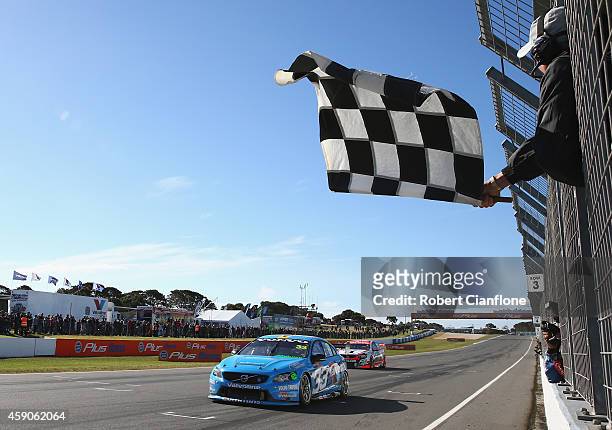 Scott McLaughlin driving the Valvoline Racing GRM Volvo gets past Garth Tander driving the Holden Racing Team Holden on the finish line during race...