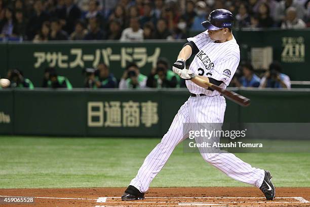 Justin Morneau of the Colorado Rockies hits an RBI double in the first inning during the game four of Samurai Japan and MLB All Stars at Tokyo Dome...