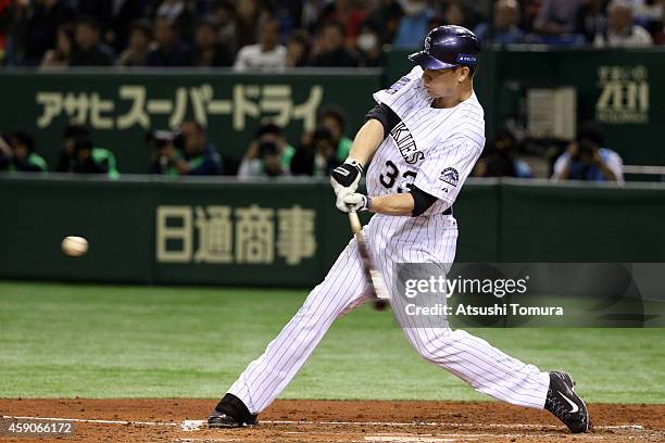 Justin Morneau of the Colorado Rockies hits three-run homer in the third inning during the game four of Samurai Japan and MLB All Stars at Tokyo Dome...
