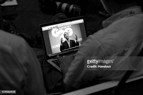 In this handout photo provided by the G20 Australia, U.S. President Barack Obama is seen on a computer creen as he addresses the media at a press...