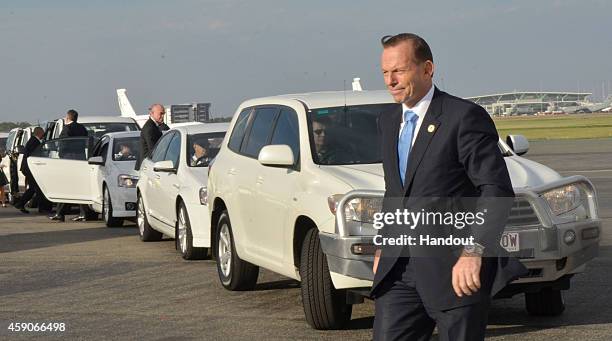 In this handout photo provided by the G20 Australia, Australian Prime Minister Tony Abbott leaves the motorcade before departing Brisbane Airport...