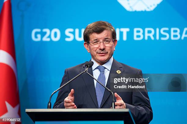 In this handout photo provided by the G20 Australia, Turkey's Prime Minister Ahmet Davutoglu addresses the media at a press conference at the...