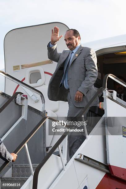 In this handout photo provided by the G20 Australia, Mauritania's President Mohamed Ould Abdel Azizof waves as he departs Brisbane after the the G20...