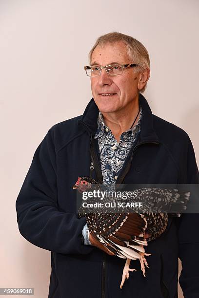 Poultry fancier Ken Leggett poses for a picture with his Speckled Sussex Bantam, which won 1st place in its class, at the National Poultry Show,...