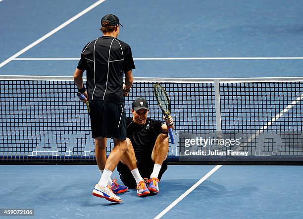 Bob Bryan of the United States helps Mike Bryan of the United States to his feet after he hit him on the head with his serve in the doubles final...